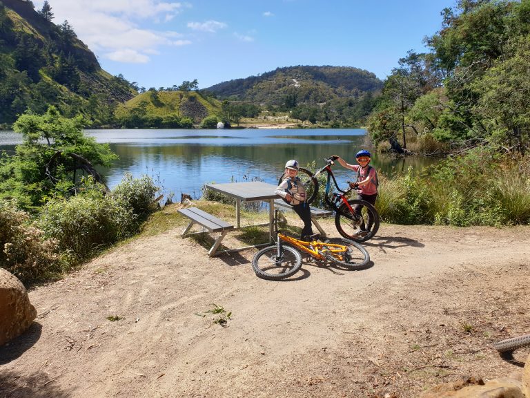 Riders enjoying the view of Lake Derby during a lesson - MTB Tasmania